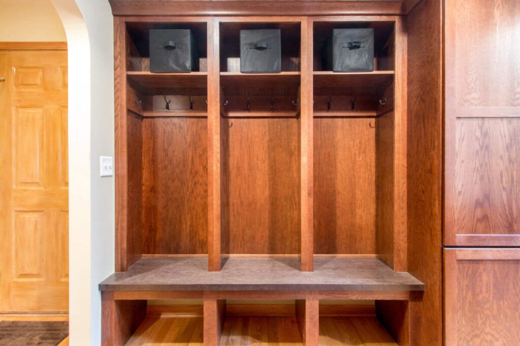 Custom wooden mudroom storage solution with hooks and cubbies designed for residential remodeling by Stebnitz Builders.